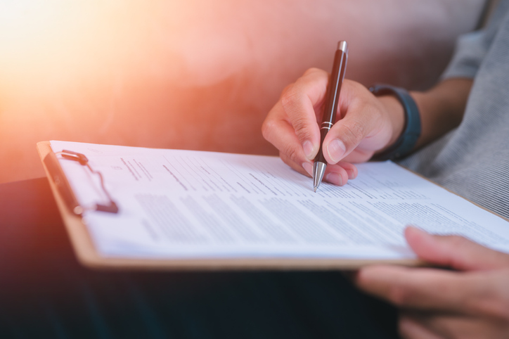 Businessman Signing Contract In The Office, Signing Contract Paper, signature on a legal document for agreement, documents and contract with a man signing paperwork Compliance, loan and insurance